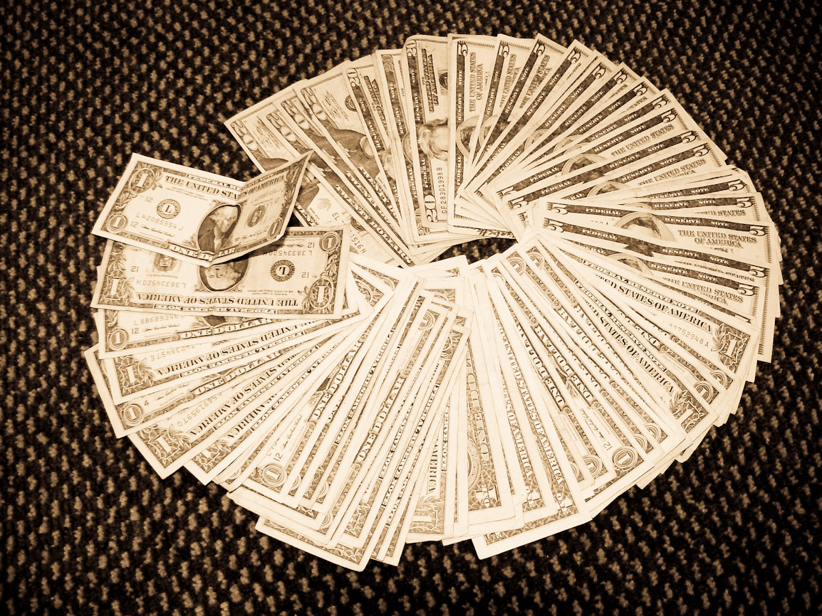 US dollars in cash lying out in a circle